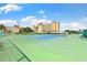 Well-maintained tennis court surrounded by lush landscaping, perfect for recreational play at 4550 Cove Cir # 501, St Petersburg, FL 33708