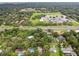 Aerial view of a neighborhood, featuring lush tree coverage and proximity to nearby schools at 6924 Greenhill Pl, Tampa, FL 33617