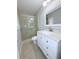 Renovated bathroom with a modern vanity, granite countertop, and glass-enclosed shower at 6924 Greenhill Pl, Tampa, FL 33617