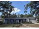 Charming single-story home with mature trees, lovely landscaping, and a welcoming walkway at 6924 Greenhill Pl, Tampa, FL 33617