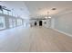 Open floor plan living area with modern kitchen, wood-look flooring, and ample natural light at 6924 Greenhill Pl, Tampa, FL 33617