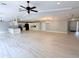 Open floor plan showcasing the kitchen and living area with wood-look flooring and recessed lighting at 6924 Greenhill Pl, Tampa, FL 33617
