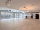 Spacious living area with vaulted ceilings, large windows, and a modern kitchen with stainless steel appliances at 6924 Greenhill Pl, Tampa, FL 33617
