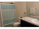 Clean bathroom with shower/tub combo and a vanity with granite countertop at 11919 Grand Kempston Dr, Gibsonton, FL 33534