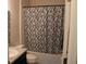 Clean bathroom with a floral shower curtain and tub at 11919 Grand Kempston Dr, Gibsonton, FL 33534