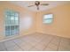 Bright bedroom with tile floors and large window at 6924 Greenhill Pl, Tampa, FL 33617