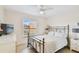 Comfortable bedroom with a metal bed frame, window, and ceiling fan at 12760 Indian Rocks Rd # 910, Largo, FL 33774