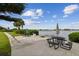 Relaxing waterfront patio with tables, chairs, and lounge chairs at 12760 Indian Rocks Rd # 910, Largo, FL 33774