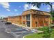Orange building exterior with ample parking and lush landscaping at 12760 Indian Rocks Rd # 910, Largo, FL 33774