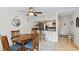Dining area with a wooden table and four chairs, open to kitchen at 12760 Indian Rocks Rd # 910, Largo, FL 33774