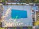 Community pool with plenty of lounge chairs at 12760 Indian Rocks Rd # 910, Largo, FL 33774