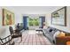 Living room with sectional sofa, window overlooking trees, and tasteful artwork at 12760 Indian Rocks Rd # 910, Largo, FL 33774