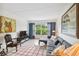 Living area with sectional sofa, window with tree view, and red and white rug at 12760 Indian Rocks Rd # 910, Largo, FL 33774