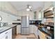 Updated kitchen with stainless steel appliances and white cabinetry at 12760 Indian Rocks Rd # 910, Largo, FL 33774