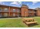 Building exterior showcasing a picnic table and ample green space at 12760 Indian Rocks Rd # 910, Largo, FL 33774