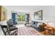 Spacious living room featuring a sectional sofa, large window, and stylish decor at 12760 Indian Rocks Rd # 910, Largo, FL 33774