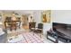 Living room with sectional sofa, rocking chair, and view to dining area at 12760 Indian Rocks Rd # 910, Largo, FL 33774