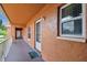 Covered hallway with individual unit entrances and outdoor views at 12760 Indian Rocks Rd # 910, Largo, FL 33774