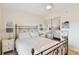 Bright bedroom with a metal bed frame and mirrored closet doors at 12760 Indian Rocks Rd # 910, Largo, FL 33774