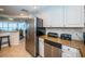 Kitchen with stainless steel appliances and granite countertops, open to living area at 1290 Gulf Blvd # 2004, Clearwater Beach, FL 33767