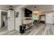 Bright living room with hardwood floors and a large TV at 2219 Beach S Blvd, Gulfport, FL 33707