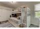 Well-lit bedroom with a bunk bed and ample closet space at 2219 Beach S Blvd, Gulfport, FL 33707