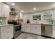 Updated kitchen with white shaker cabinets, stainless steel appliances, and quartz countertops at 2219 Beach S Blvd, Gulfport, FL 33707
