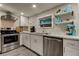 Updated kitchen with white cabinets, stainless steel appliances, and quartz countertops at 2219 Beach S Blvd, Gulfport, FL 33707