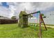 Large backyard with a playset and plenty of green space at 2219 Beach S Blvd, Gulfport, FL 33707
