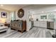 Open concept kitchen boasts white cabinets, stainless steel appliances, and a stylish backsplash at 2219 Beach S Blvd, Gulfport, FL 33707