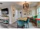 Dining area with a wooden table, teal chairs, and a chandelier at 2219 Beach S Blvd, Gulfport, FL 33707