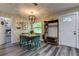 Dining area with a wooden table, teal chairs, and entryway view at 2219 Beach S Blvd, Gulfport, FL 33707