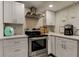 Modern kitchen with white cabinets, stainless steel appliances, and a light and airy feel at 2219 Beach S Blvd, Gulfport, FL 33707
