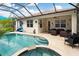 Inviting pool and spa with covered patio and seating area at 4359 70Th Street E Cir, Palmetto, FL 34221