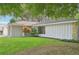 Side view of the house showcasing a light gray exterior and landscaping at 6605 Pointe West Blvd, Bradenton, FL 34209