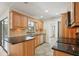 Modern kitchen with wood cabinets, granite counters and stainless steel appliances at 6605 Pointe West Blvd, Bradenton, FL 34209