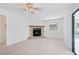 Living area featuring a stone fireplace and sliding doors to the pool area at 6605 Pointe West Blvd, Bradenton, FL 34209