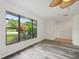 Bright living room with wood-look floors and large window offering backyard view at 6605 Pointe West Blvd, Bradenton, FL 34209