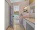 Bathroom with single sink vanity, and access to bedroom and walk-in shower at 34802 Double Eagle Ct, Zephyrhills, FL 33541