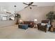 Spacious living room with leather sofa, armchair, and ceiling fan at 34802 Double Eagle Ct, Zephyrhills, FL 33541