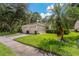 Two-car garage, light beige exterior, and manicured lawn at 34802 Double Eagle Ct, Zephyrhills, FL 33541