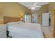 Relaxing bedroom with a king-size bed, ceiling fan, and built-in shelving at 34802 Double Eagle Ct, Zephyrhills, FL 33541