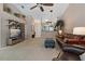 Open living room showcasing a leather sofa and a view of the kitchen and entryway at 34802 Double Eagle Ct, Zephyrhills, FL 33541