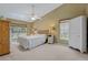 Bright bedroom with king bed, dual windows, and wood armoire at 34802 Double Eagle Ct, Zephyrhills, FL 33541