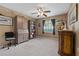 Bedroom with carpeted floor, built-in bookcase and window at 34802 Double Eagle Ct, Zephyrhills, FL 33541