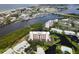 Aerial view of waterfront community, featuring a multi-story building, pool, and tennis courts at 11590 Shipwatch Dr # 548, Largo, FL 33774