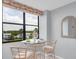 Charming breakfast nook with a glass-top table and chairs near a window at 11590 Shipwatch Dr # 548, Largo, FL 33774