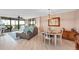 Bright dining area with a table and chairs, hardwood floors, and a view at 11590 Shipwatch Dr # 548, Largo, FL 33774