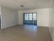 Bright living room with tile floors and sliding glass doors to patio at 8119 San Bernardino Dr, Port Richey, FL 34668