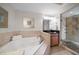 Elegant bathroom boasts a soaking tub, glass-enclosed shower, and modern vanity at 15 Somerset St # 6A, Clearwater Beach, FL 33767